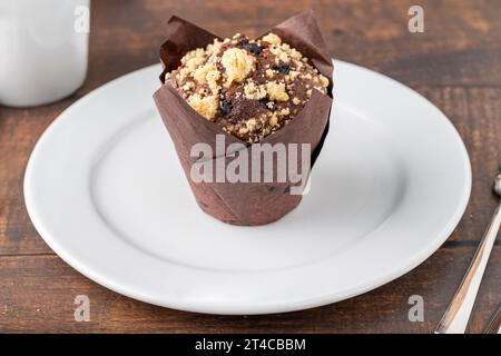 Chocolate muffin or cupcake with coffee on wooden table Stock Photo