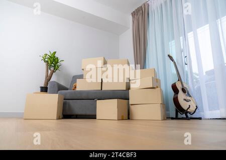 Mortgage, people and real estate concept, Many boxes moving to new home. Stock Photo