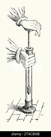 An old engraving demonstrating using a condensing or pneumatic syringe. It is from Victorian book of the 1890s on sports, games and pastimes. A pneumatic (or fire) syringe demonstrated that, when air is rapidly condensed or compressed, its temperature rises markedly. Here an air-tight piston or barrel within a glass tube is plunged downwards. A few thrusts will quickly increase the temperature at the base of the tube. If a small piece of ‘guncotton’ is placed at the base, it will ignite and start to burn. Stock Photo