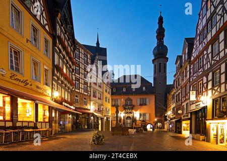 market square with town hall, half-timbered houses and tower of the parish church of St. Martin in the evening, Germany, Rhineland-Palatinate, Cochem Stock Photo