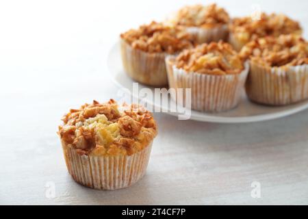 Juicy muffins with apple and cinnamon, sweet homemade pastry, seasonal baking in autumn, copy space, selected focus, narrow depth of field Stock Photo