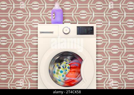 Modern electronic washing machine with rotating colorful laundry in front of retro wallpaper Stock Photo