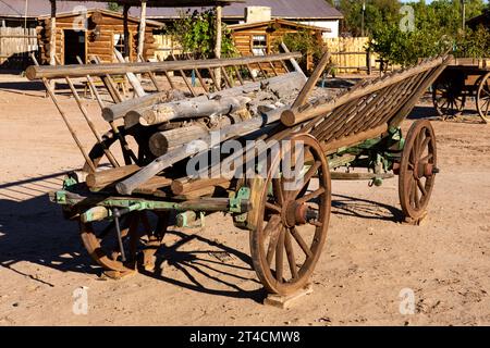A vintage antique wooden hay wagon with sloped sides at the Bluff Fort Historic Site in Bluff, Utah. Stock Photo