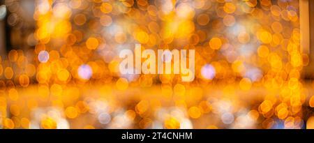 Blurred holiday background with bokeh. Defocused New Year and Christmas illumination. High quality photo Stock Photo