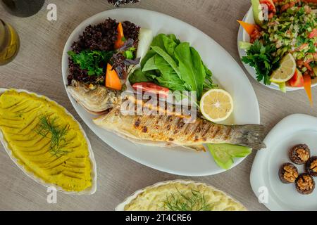 A picture from above of a table with dishes of fish and seafood appetizers Stock Photo