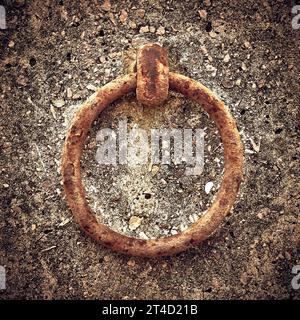 Rusty metal ring attached to concrete wall Stock Photo