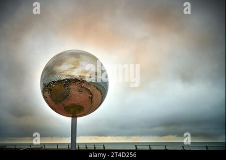 Artwork 'They shoot horses don't they' giant mirror ball on Blackpool seafront before the storm hits Stock Photo