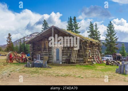 Log cabin homestead accessible only on 'Top of the World Highway' which is closed in winter and is only passable in the summer months. Stock Photo