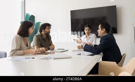 Serious diverse business colleagues discussing work on project Stock Photo
