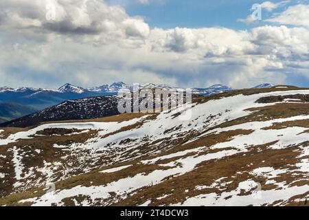 Snow on mountain and hill sides, viewed from the 'Top of the World Highway' or Yukon Highway 9. Highway between Dawson City, Yukon, and Alaska. Stock Photo