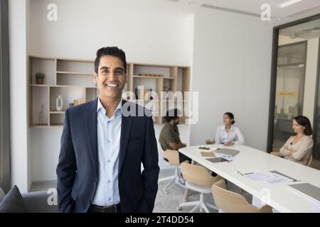 Happy handsome successful businessman enjoying work with diverse team Stock Photo