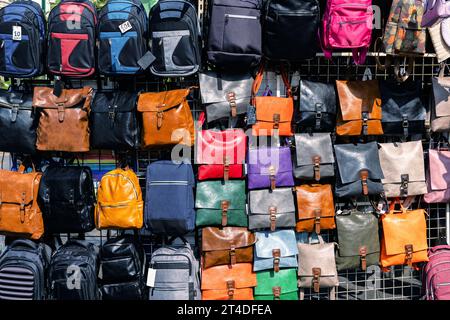 Backpacks and bags, shape and size, on display in a retail store. Backpacks supplies of various manufacturers. Stock Photo