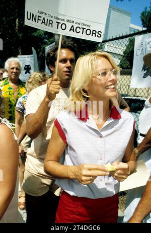 RANDI OAKES (foreground) ; American actress and fashion model ;  GREGORY HARRISON ;  American actor ;  at a demo for the SAG - AFTRA actors strike ;  1980 ;  Credit : Lynn McAfee / Performing Arts Images ;  www.performingartsimages.com Stock Photo