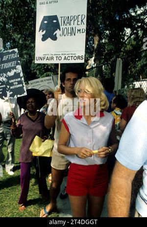 RANDI OAKES (foreground) ; American actress and fashion model ;  GREGORY HARRISON ;  American actor ;  at a demo for the SAG - AFTRA actors strike ;  1980 ;  Credit : Lynn McAfee / Performing Arts Images ;  www.performingartsimages.com Stock Photo