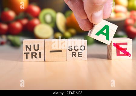 Hand changing the expression nutri-score E to nutri-score A. Stock Photo