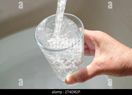 filling glass with tap water Stock Photo