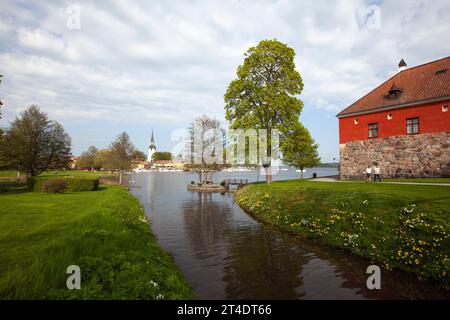 GRIPSHOLM CASTLE, SWEDEN ON MAY 11, 2018. View of the moat around the castle. Church and lake. Unidentified men. Editorial use. Stock Photo