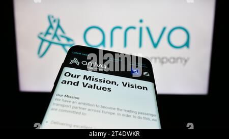 Smartphone with webpage of British public transport company Arriva plc in front of business logo. Focus on top-left of phone display. Stock Photo