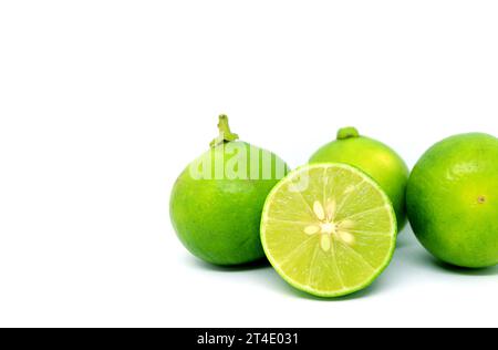Closeup of Half cut fresh lime with whole fruits isolated on white background Stock Photo