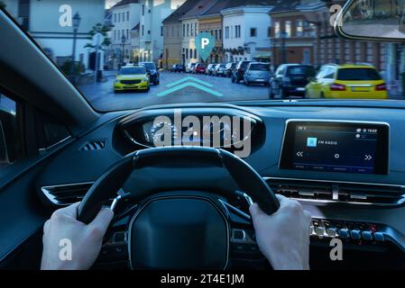 Inteligent car navigation to parking place concept. View from the driver's perspective Stock Photo