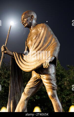 The statue of Mahatma Gandhi situated on the Belgrave Road, Leicester. The picture was taken at night with the light of the moon shining on the statue. The statue has been the scene of protests to remove the statue. The statue sits alongside the Golden Mile, the area where the main Diwali celebrations are held every year. Stock Photo