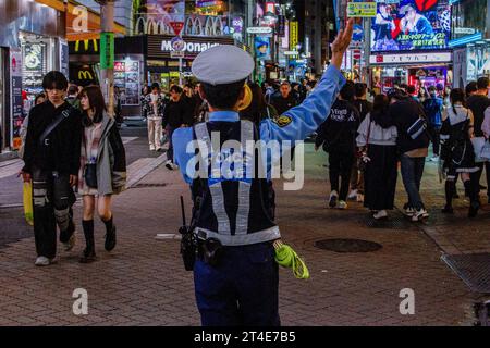 Tokyo, Japan. 29th Oct, 2023. Police control crowds in Center Gai to limit Halloween celebrations. Sunday, October 29th, 2023. In an effort to avoid disruption to locals and ensure safety the mayor of Shibuya ward, Ken Hasebe, urged people to refrain from visiting Shibuya for Halloween reinforcing this message with alcohol bans; a large police presence, and giant billboards saying there would be no festivities this year. Credit: SOPA Images Limited/Alamy Live News Stock Photo