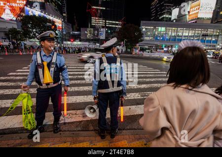 Tokyo, Japan. 29th Oct, 2023. Police control crowds at Shibuya Scramble crossing to limit Halloween celebrations. Sunday, October 29th, 2023. In an effort to avoid disruption to locals and ensure safety the mayor of Shibuya ward, Ken Hasebe, urged people to refrain from visiting Shibuya for Halloween reinforcing this message with alcohol bans; a large police presence, and giant billboards saying there would be no festivities this year. Credit: SOPA Images Limited/Alamy Live News Stock Photo