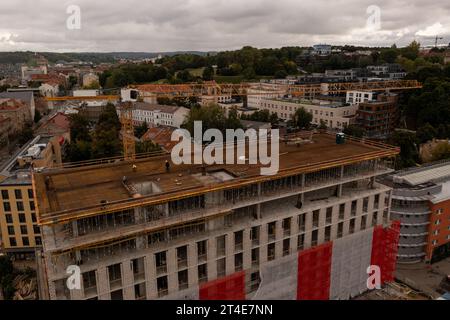 Drone photography of new building construction site, crane and cityscape during cloudy autumn day Stock Photo