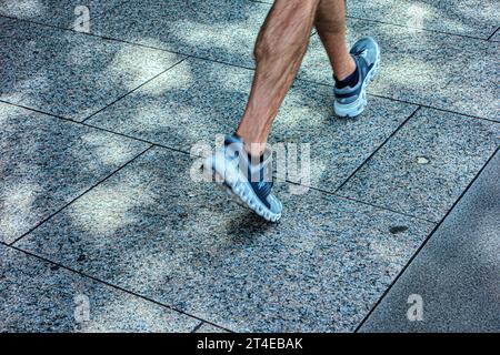 Close-up of feet walking, wearing sneakers or trainers Stock Photo