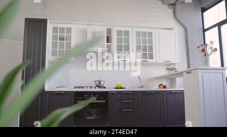 Modern kitchen interior. Rich, white and black set. Beautiful, modern kitchen set. Elegant kitchen interior with accessories. Stock Photo