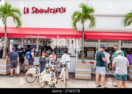 Miami Beach Florida,outside exterior,building La Sandwicherie,counter ordering line queue,man men male,woman women lady female,adults,restaurant dine Stock Photo