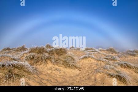 Fog Bow over the beach in Southwold, Suffolk England UK Stock Photo