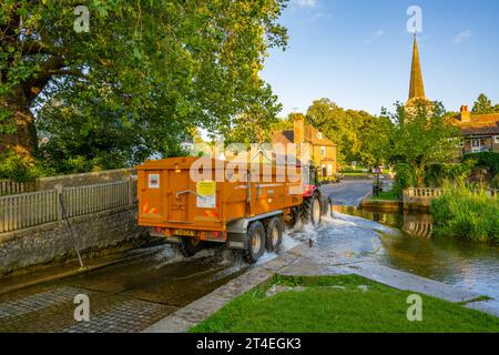 Tractor and trailer crossing, The River Darent and the ford, at Eynesford Kent, on a summer evening Stock Photo