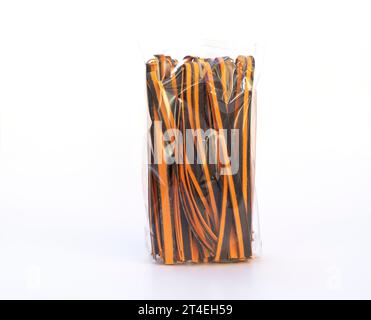 Black And Orange Pappardelle Italian Pasta In Package, Fresh Wheat Product on White Background. Egg Dry Ribbon Noodles, Long Rolled Macaroni or Stock Photo