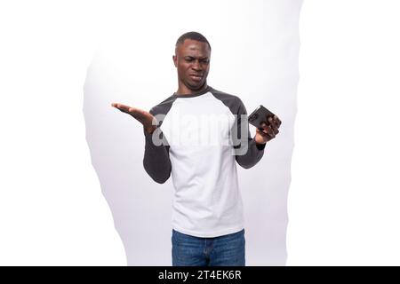young american guy with short hair is watching video on phone Stock Photo