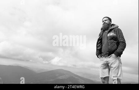 caucasian man having moustache, banner. photo of caucasian man in the mountain. caucasian man outdoor. caucasian man has beard. Stock Photo