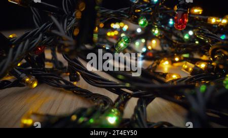 Christmas garland with multi colored bulbs and lights, Christmas, coloured small lights close up. Electric, abstract. Stock Photo