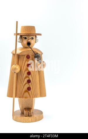 Closeup of a original handcarved wooden German Christmas Shepherd Smoking Man figurine on a white background Stock Photo