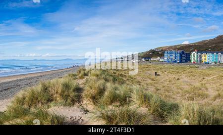 A multi image panorama Barmouth seafront where  colourful hotels line and the sand dunes seperate the land and sea on the Welsh coastline. Stock Photo