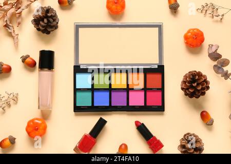 Autumn composition with different makeup products on beige background Stock Photo