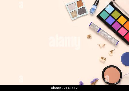 Composition with different makeup products and beautiful flowers on light background Stock Photo
