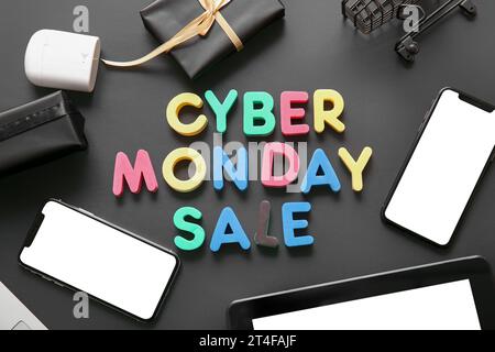 Text Cyber Monday Made Of Black Letters, Gadgets And Gift Boxes On 