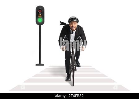 Businessman in a suit riding a bicycle at a pedestrian crossing isolated on white background Stock Photo