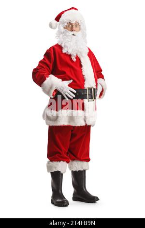 Full length portrait of young santa claus standing with hands on his belly and looking surprised isolated on white background Stock Photo