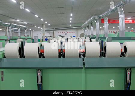 LUANNAN COUNTY - AUGUST 23: Machinery equipment and cotton in a spinning workshop, on august 23, 2014, Luannan County, Hebei Province, China Stock Photo