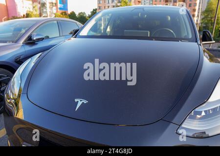 Almaty, Kazakhstan - August 18, 2023: Tesla emblem on the hood of model 3. Electric car Stock Photo