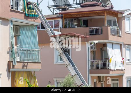 Aerial lift platform on a truck, a straightened lift arm and a lifting platform for lifting goods to the upper floors, for example furniture and other Stock Photo