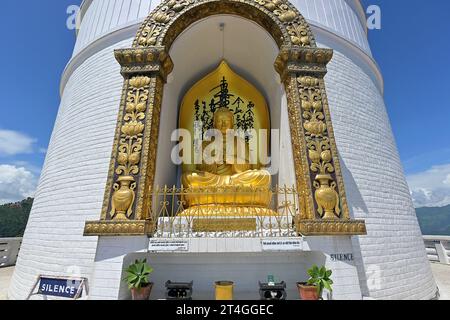 The Shanti Peace Pagoda in Pokhara, Nepal with seated Buddha image in preaching pose with Dharmachakra mudra Stock Photo