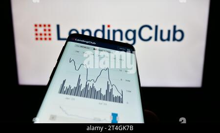 Smartphone with website of US financial services company LendingClub Corporation in front of business logo. Focus on top-left of phone display. Stock Photo