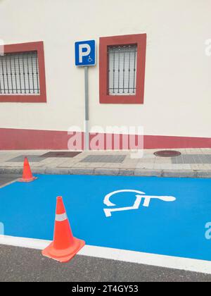 Reserved parking for vehicles of people with disabilities. Just painted floor signal Stock Photo